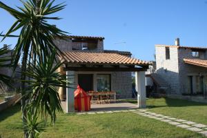 卡斯蒂亚达斯Villa Cala Sinzias的一个带桌子和红色风筝的房子