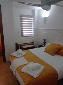 乌贝达La Casita的一间卧室配有两张带毛巾的床