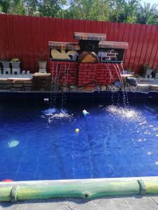 大港Chalet kolam renang D'sawah的游泳池中间设有喷泉