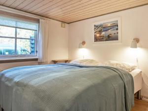 内克瑟Holiday home Nexø XLI的一间卧室设有一张床和一个窗口