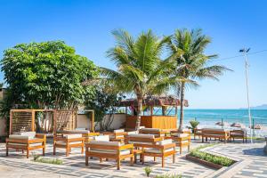 弗洛里亚诺波利斯Ingleses Palace Hotel的海滩上设有椅子和凉亭,海洋上设有