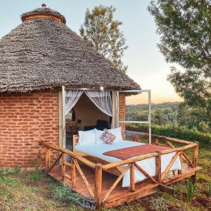 卡拉图Foresight Eco Lodge & Safari的茅草屋顶砖砌的一张床位