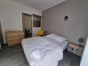 科特雷Coeur de Cauterets appartement 53m² 4/6 personnes的卧室配有白色的床和黄色椅子