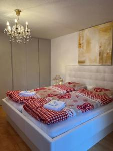 采尔马特千禧年公寓的一间卧室配有一张带红白毯子的床