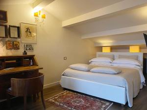 圣马力诺B&B Balsimelli12的卧室配有白色的床、书桌和桌子