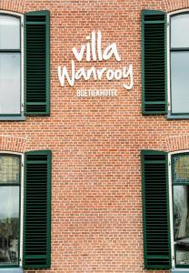 多廷赫姆Villa Wanrooy的砖砌的建筑,旁边标有标志