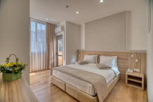 埃里温Orbeli Hotel Yerevan的一间卧室设有一张大床和一个大窗户