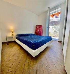 莱维科特尔梅APPARTAMENTO ELISA的一间卧室配有一张带蓝色棉被的床