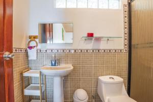曼努埃尔安东尼奥Villas de la Selva的一间带水槽、卫生间和镜子的浴室
