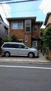 东京Homestay Intimo Amigo的停在房子前面的银面包车