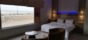 索哈尔Marina H的一间卧室配有一张床,享有海滩美景