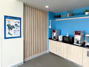 曼谷Hop Inn Bangkok Bangna的一间咖啡厅,内设柜台和蓝色的墙壁
