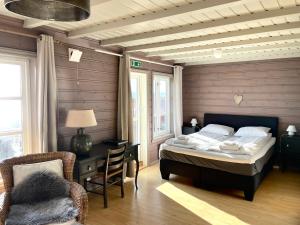 OsøyroBjørnafjorden Hotell的一间卧室配有一张床、一张桌子和一把椅子