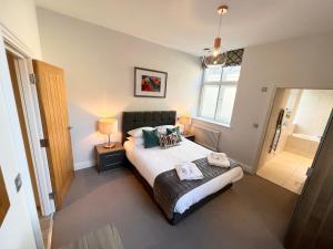 温莎Urban Living's - Windsor Castle Luxury Apartments的一间卧室配有一张带两个枕头的床