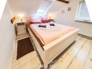 博恩海姆Friendly Home - "Helles Dachstudio" Köln Bonn Phantasialand的卧室配有一张带粉红色枕头的大床