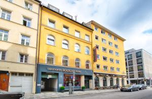 慕尼黑慕尼黑莱昂纳多精品酒店的街道边的黄色建筑