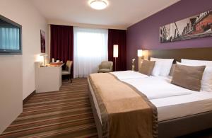 科隆科隆莱昂纳多酒店的酒店客房设有一张大床和一张书桌。