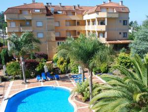 里博雷多Hotel Spa Bosque mar的享有酒店空中景致,设有游泳池和棕榈树