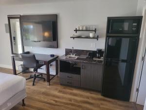 瓦列霍Motel 6 Vallejo, CA - Napa Valley的客房设有带书桌和冰箱的厨房。