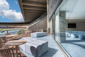 赫雷斯-德拉弗龙特拉B&B HOTEL Jerez的大楼内的阳台配有桌椅