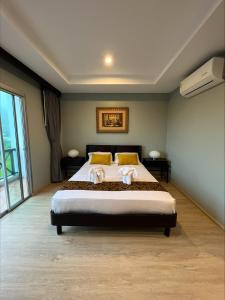 卡塔海滩Aloha Residence的一间卧室配有一张大床和两个枕头