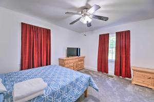杰克逊维尔Convenient Jacksonville Home with Yard and Patio!的一间卧室配有一张床和吊扇