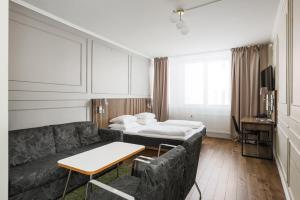 林雪平Comfort Hotel Linköping City的客厅配有沙发和1张床