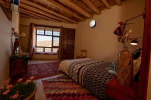 Zawyat OulmziTouda Ecolodge Atlas Mountains的一间卧室设有一张床和一个窗口