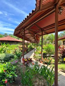 奎波斯城大森林自然度假村酒店的花园,花园内有种有鲜花和植物的凉亭