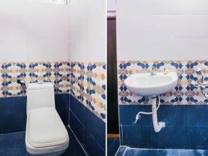 海得拉巴HZ INN的浴室配有白色卫生间和盥洗盆。