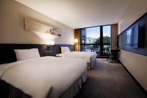 新店白金花园酒店的酒店客房设有两张床和一台平面电视。