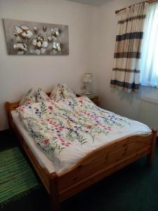 埃尔毛Haus Auebach的卧室内一张带花卉棉被的床