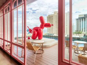 芭堤雅市中心Mytt Hotel Pattaya - SHA Extra Plus的阳台上设有大红象雕像