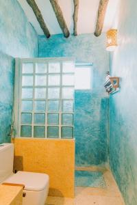 布韦朱Mkunguni Villas的蓝色的浴室设有卫生间和窗户。