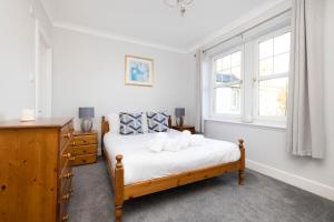爱丁堡JOIVY Modern flat with free parking的一间卧室设有一张床和两个窗户。