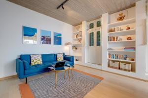 森格莱阿Traditional Maltese Townhouse wt Terrace and Pool的客厅配有蓝色的沙发和桌子