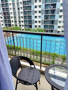 Bandar PenawarPangsapuri Desaru Utama Homestay的阳台配有两把椅子,享有水景