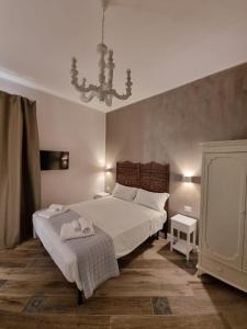 那不勒斯Real Giardinetto a Toledo的卧室配有一张白色大床和吊灯。