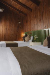圣赫拉多德多塔Lauraceas Lodge的木镶板客房内的两张床