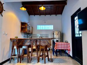 多拉代尔Cabaña La Aldea - Santorini Colombiano的厨房设有带凳子的木制酒吧