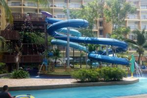 万津Gold Coast Morib Seaview 2 rooms Aircond Apartment的一个带游泳池的度假村内的水滑梯