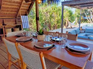 内布拉拉Villa Oemodo 3 bedrooms的一张木桌,上面放有盘子和酒杯