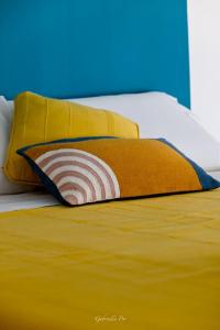 马鲁焦Casa Vacanza Le Dune - Mare的一张带黄色枕头和两个黄色枕头的床
