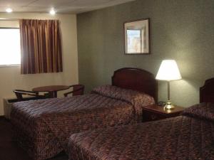 哥伦布德国村汽车旅馆的酒店客房设有两张床和一张桌子。