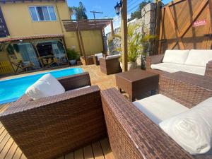 弗洛里亚诺波利斯Hotel Fênix的游泳池旁带柳条家具的庭院