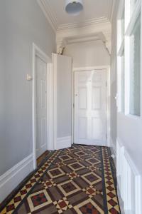 纽波特Handpost Retreat的走廊上设有门,铺有瓷砖地板