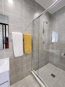 巴利托Ballito Hills Lifestyle Estate Unit 423的一间带黄色毛巾淋浴的浴室