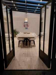 拉纳肯Entre Deux Eaux的一间设有白色桌子和玻璃门的用餐室