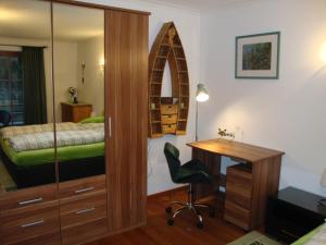 基茨比厄尔Haus Andreas的一间带书桌的卧室和一间带床的卧室