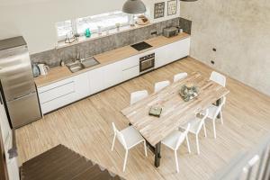 马鲁佩Marupes pirts的厨房配有木桌和白色椅子